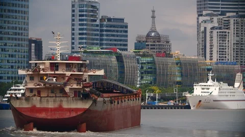 Skyscrapers and a ship floating on the river in Shanghai by day Stock Footage 99473102
