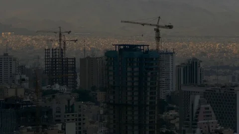 Skyscrapers construction, ray of sun light on top of buildings of Tehran Iran Stock Footage 70879067