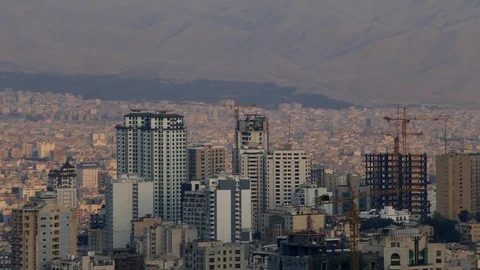 Skyscrapers construction tower cranes sun light on buildings cityscape of Tehran Stock Footage 70868360