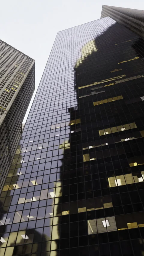 Skyscrapers create dramatic shadows in urban cityscape at dusk Stock Footage 325074894