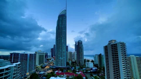 Skyscrapers dominate the skyline under a dramatic, cloudy sky at dusk Stock Footage 312677384