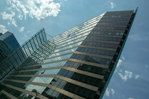 Skyscrapers with reflection of white clouds Stock Photos