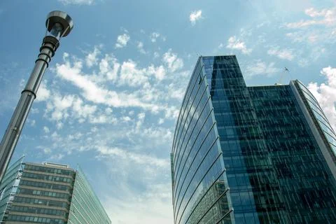Skyscrapers with reflection of white clouds Stock Photos