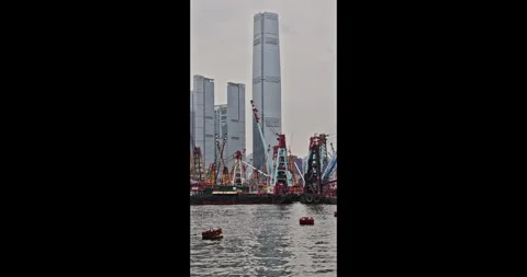 Skyscrapers standing over construction barges, Hong Kong Victoria Harb Stockbeeldmateriaal 343663505