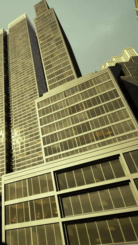 Skyscrapers touching the clouds in a bustling urban landscape at sunset 库存影片 335448926