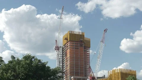 Skyscrapers Under Construction with Sunlit Clouds Stock Footage 77282601