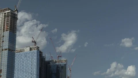  Skyscrapers Under Construction with Sunlit Clouds Stock Footage 77284938