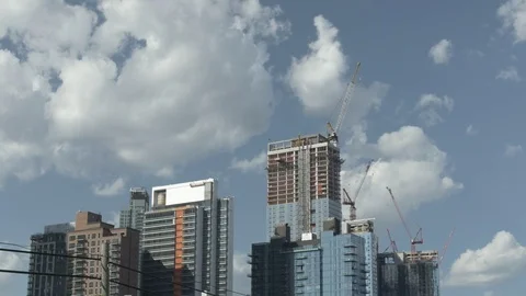 Skyscrapers Under Construction With Sunlit Clouds Stock Footage 77302263