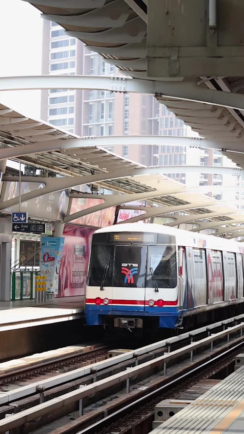 Skytrain Arriving at Elevated Urban Station in Bangkok Stock Footage 323679775