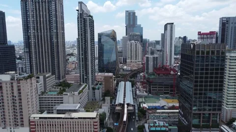 The Skytrain departs from a BTS train station in Bangkok, Thailand 4K Stock Footage 244310414