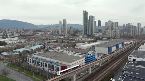 Skytrain Moving Through Burnaby, British Columbia, With Brentwood Town Centre Vídeo Stock 332678599