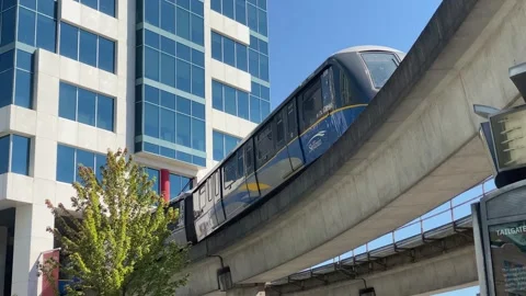 Skytrain Pan from Corporate Building to Mountain Stock Footage 280879328