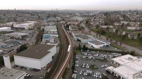 Skytrain Passing On Elevated Transit Line Through Industrial And Commercial Stock-Footage 332678212