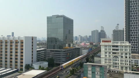 Skytrain Pulls Into Bang Chak BTS Station Summer Bangkok Thailand Drone Rise 4K 스톡 동영상 337547440
