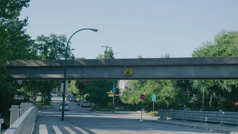 Skytrain subway train passing overhead of street Stock Footage 103395256