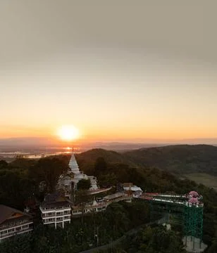 Skywalk and temple complex silhouetted against the evening sky. The sunset .. Stock Photos
