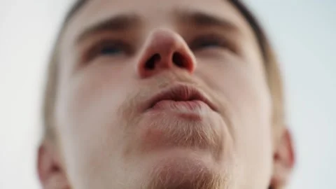Skyward heroic gaze. Urban protector fixates on expansive skies above him Stock Footage 332365435