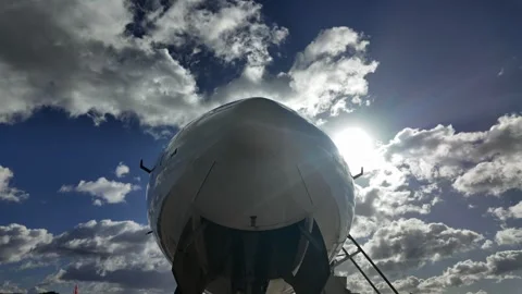 Skyward perspective with the closeup view of the nose of a jet under a blue sky Stock Footage 297656375