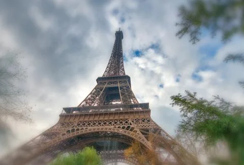 Skyward view of Eiffel Tower on a cloudy winter day - France Stock Photos