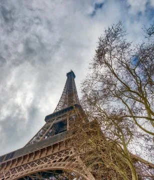 Skyward view of Eiffel Tower on a cloudy winter day - France Stock Photos