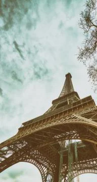 Skyward view of Eiffel Tower on a cloudy winter day - France Stock Photos
