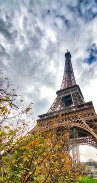 Skyward view of Eiffel Tower on a cloudy winter day - France Stock Photos