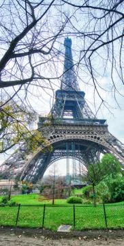 Skyward view of Eiffel Tower on a cloudy winter day - France Stock Photos