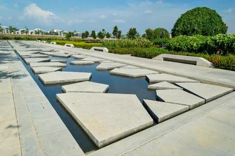 Slab concrete with pattern and reflection at green garden area Stock Photos