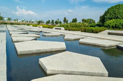 Slab concrete with pattern and reflection at green garden area Stock Photos