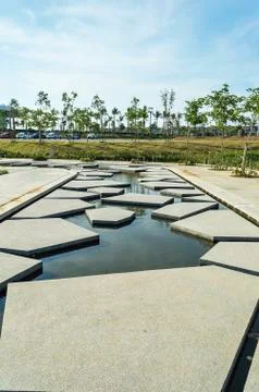 Slab concrete with pattern and reflection at green garden area Stock Photos