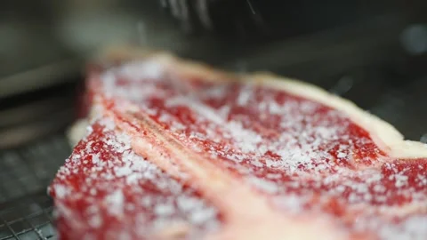 A slab of meat is covered in salt Stock Footage 301517337