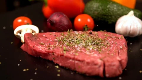 Slab of tender raw beef steak being seasoned Stock-Footage 105110860