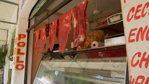 Slabs of raw meat hang in open air butcher shop Huatulco Vídeo Stock 107022787
