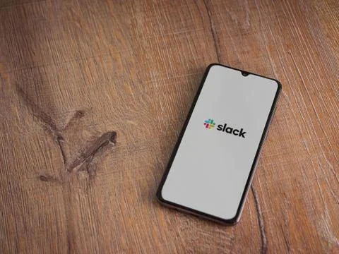 Slack app launch screen with logo on the display of a black mobile smartphone Stock Photos