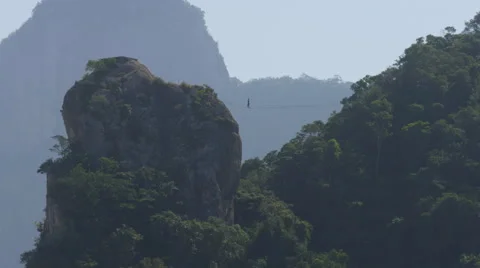 Slackline athlete without pole between two mountains Stock Footage 68735091