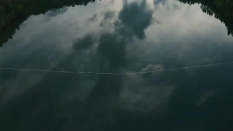 Slackline balanced walk over large chasm of pristine water and woods. High 2 Stock Footage 158402855