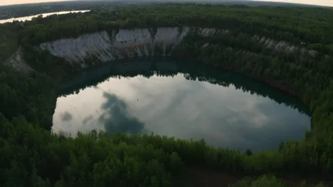 Slackline balanced walk over large chasm of pristine water and woods. High 6 Stock Footage 158402930