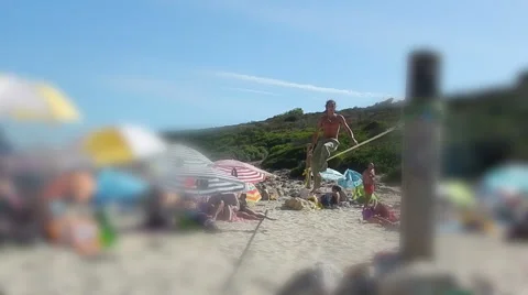 Slackline performance on crowded beach selective focus. Stock Footage 43386609