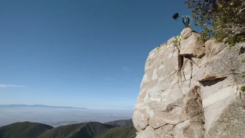 Slackliner throws line and bag in slow motion Stock Footage 90818955