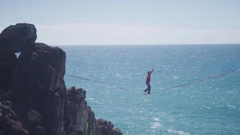 Slacklining over the Ocean Cliff Stock Footage 264059486