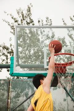 Slam dunk by young man Stock Photos
