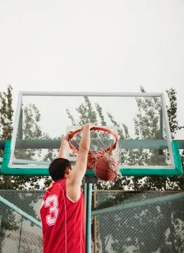 Slam dunk by young man Stock Photos