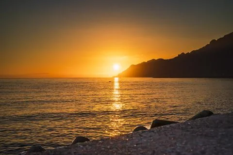 Slanting rays of the setting sun hitting the coastline along Amalfi Coast Stock Photos