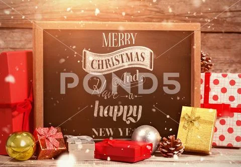 Slate amidst gifts, pine cones and ornaments PSD Template