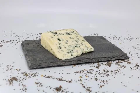 Slate cheese platter with a slice of Bleu (blue cheese with sheep's milk) Stock Photos