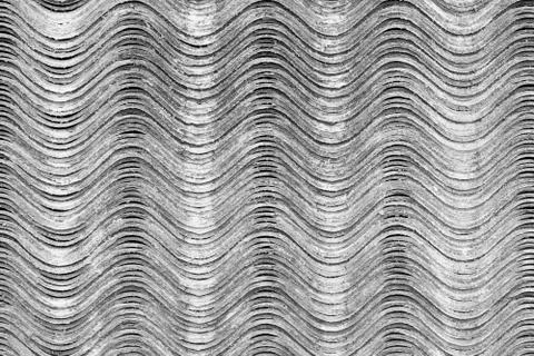 Slate sheets lie on top of each other and form a horizontal undulating surfac Stock Photos