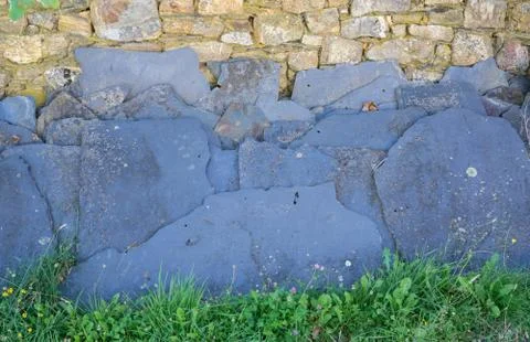 Slate sheets over stone wall, abandoned Stock Photos