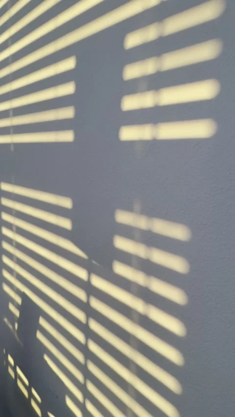 Slatted Sun Shadow Pattern on Smooth Wall Stock Footage 345922781