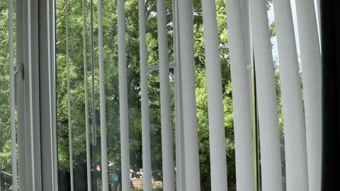 Slatted window blinds swaying in the summer breeze Video stock 138031466