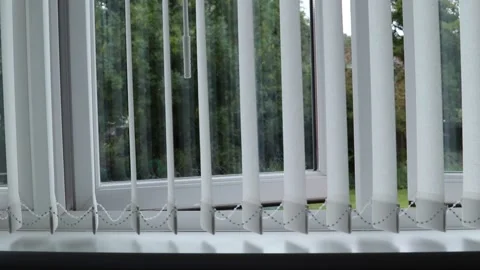 Slatted window blinds swaying in the summer breeze Video stock 138031474
